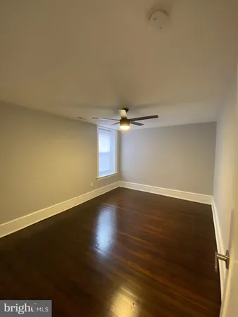 an empty room with wooden floor