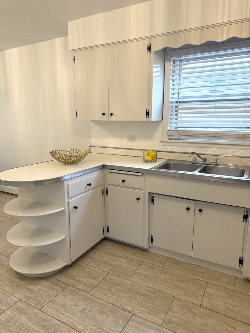 2308 Oakton Street, Unit 1 Park Ridge, IL 60068 - Photo 6 of 8 a kitchen with a sink cabinets and a window