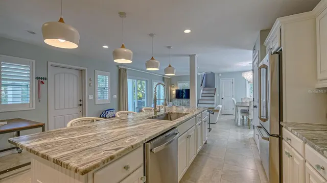 a spacious bathroom with a granite countertop sink and a mirror