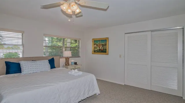 a bedroom with a large bed and a window