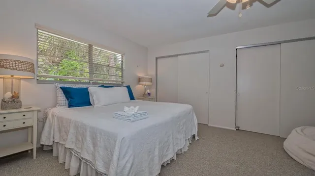 a bedroom with a bed and window