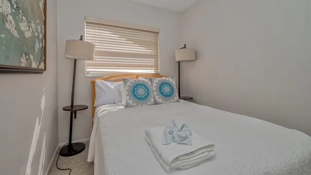 a bedroom with a bed and a window