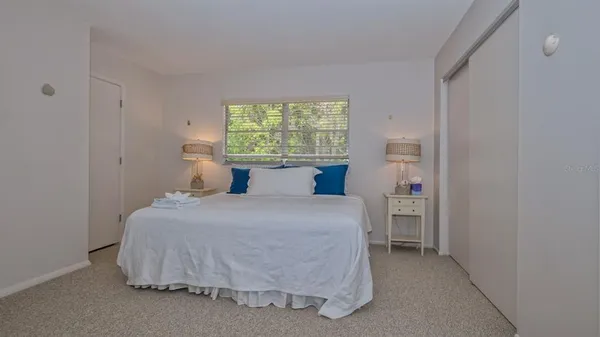 a bedroom with a bed and window