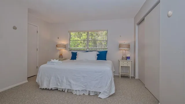 a bedroom with a bed and window