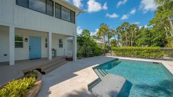 a view of backyard with outdoor seating and green space
