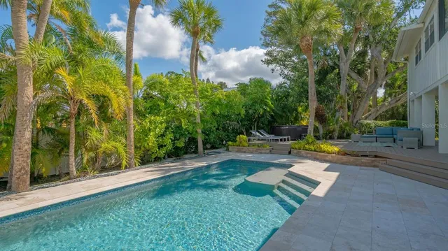 a view of a backyard with swimming pool