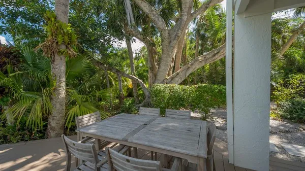 a view of a patio with table and chairs and potted plants