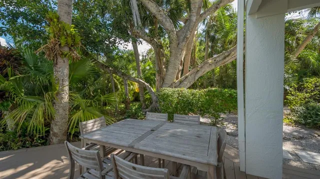a view of a patio with table and chairs and potted plants
