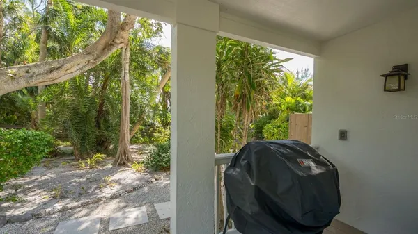 a view of balcony with furniture and garden