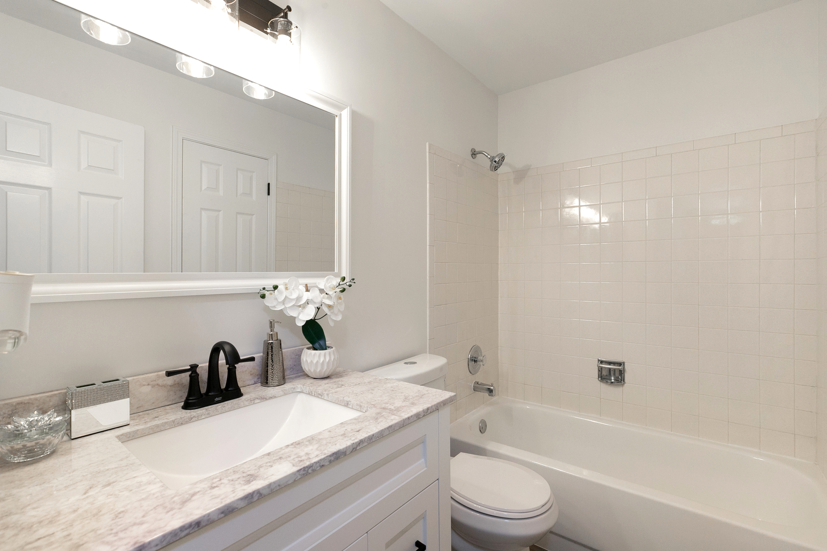1900 Gresham Circle, Unit B Wheaton, IL 60189 - Photo 11 of 19 a bathroom with a granite countertop bathtub sink vanity mirror and toilet