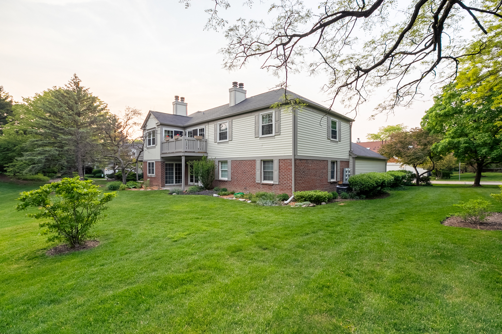 1900 Gresham Circle, Unit B Wheaton, IL 60189 - Photo 18 of 19 a front view of a house with a garden