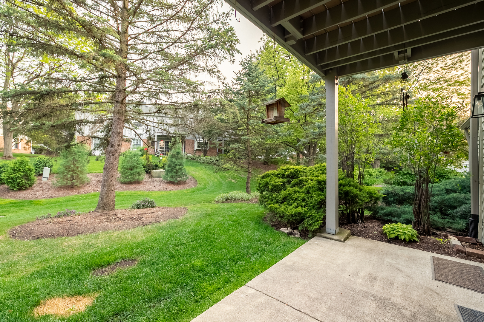 1900 Gresham Circle, Unit B Wheaton, IL 60189 - Photo 19 of 19 a backyard of a house with plants and large trees