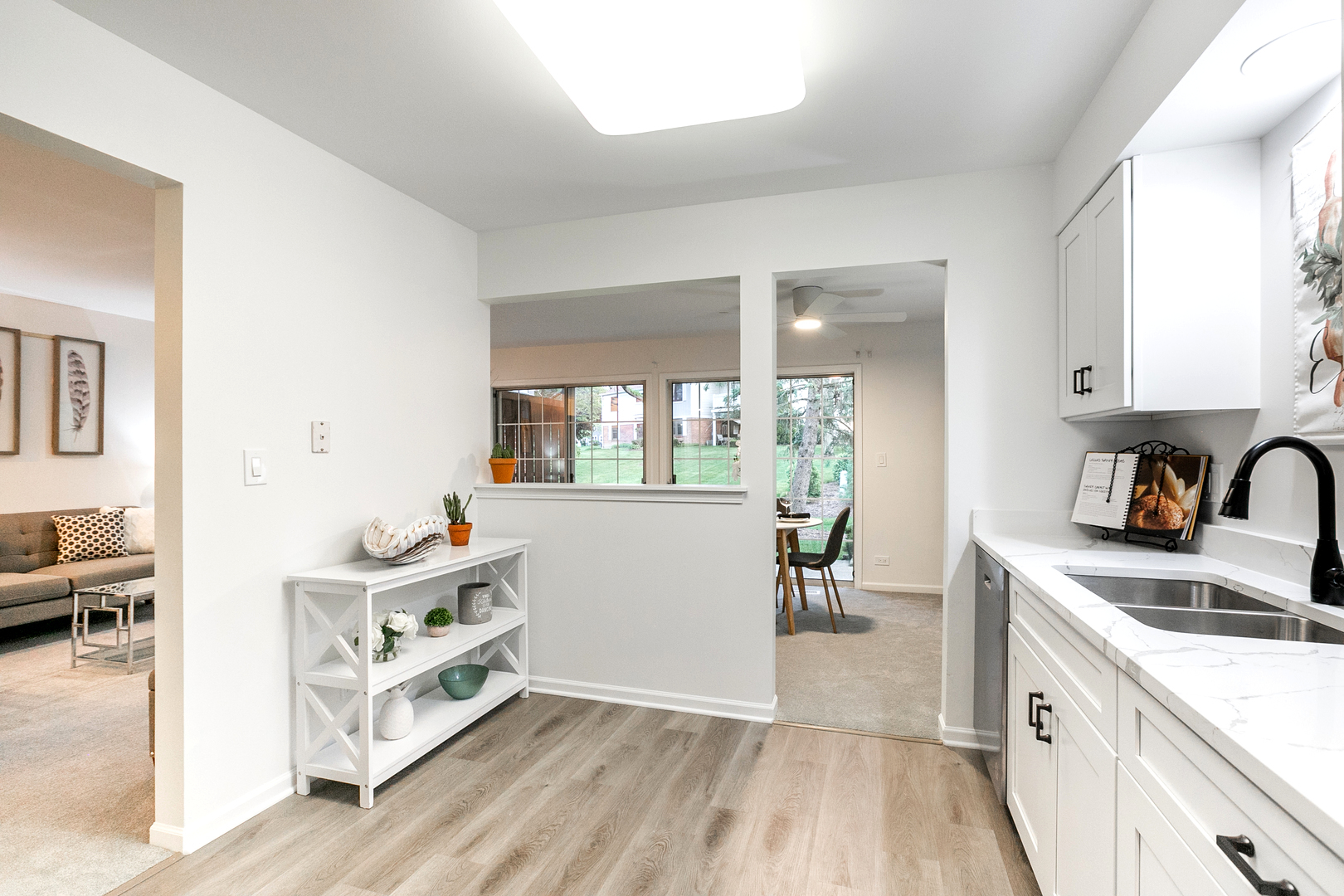1900 Gresham Circle, Unit B Wheaton, IL 60189 - Photo 9 of 19 a kitchen that has a sink and a stove with wooden floor