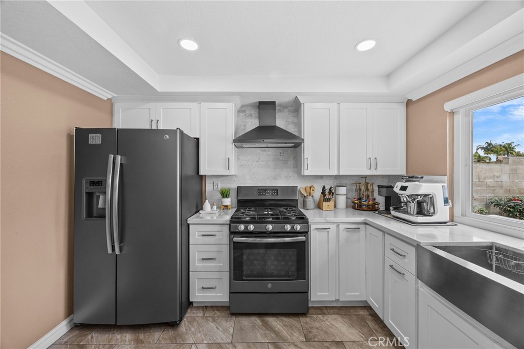 20257 Edmund Road Riverside, CA 92508 - Photo 14 of 53 a kitchen with a stove sink and refrigerator