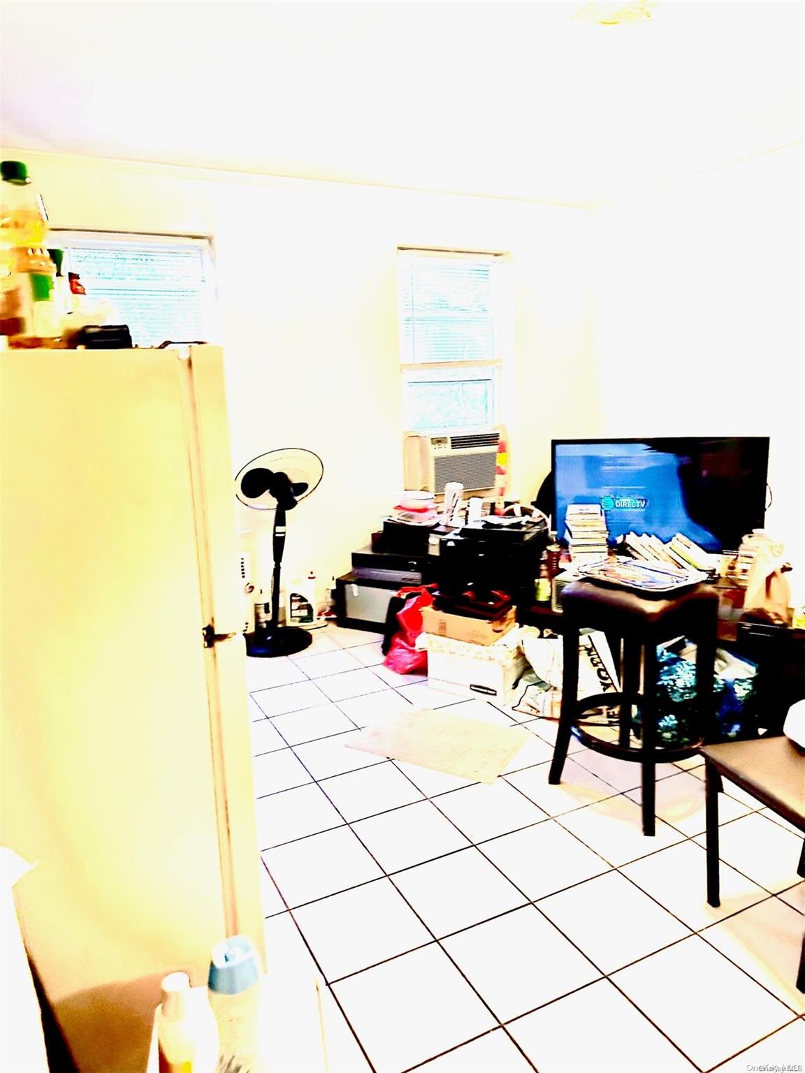 67-36 Austin Street Queens, NY 11375 - Photo 3 of 6 a living room with a couch and a table