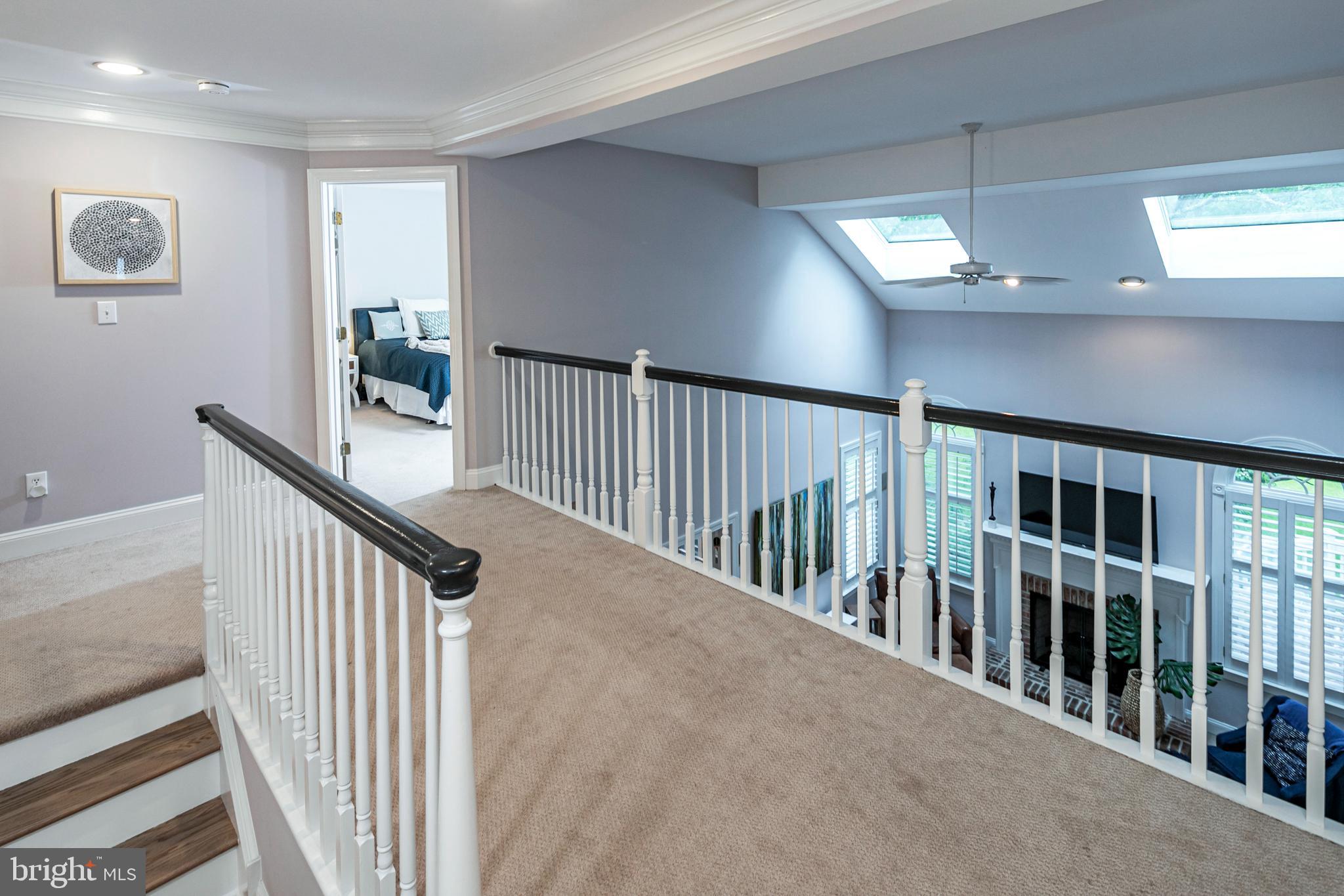 173 Christopher Drive Princeton, NJ 08540 - Photo 28 of 61 a view of staircase with lots of frames on wall and windows