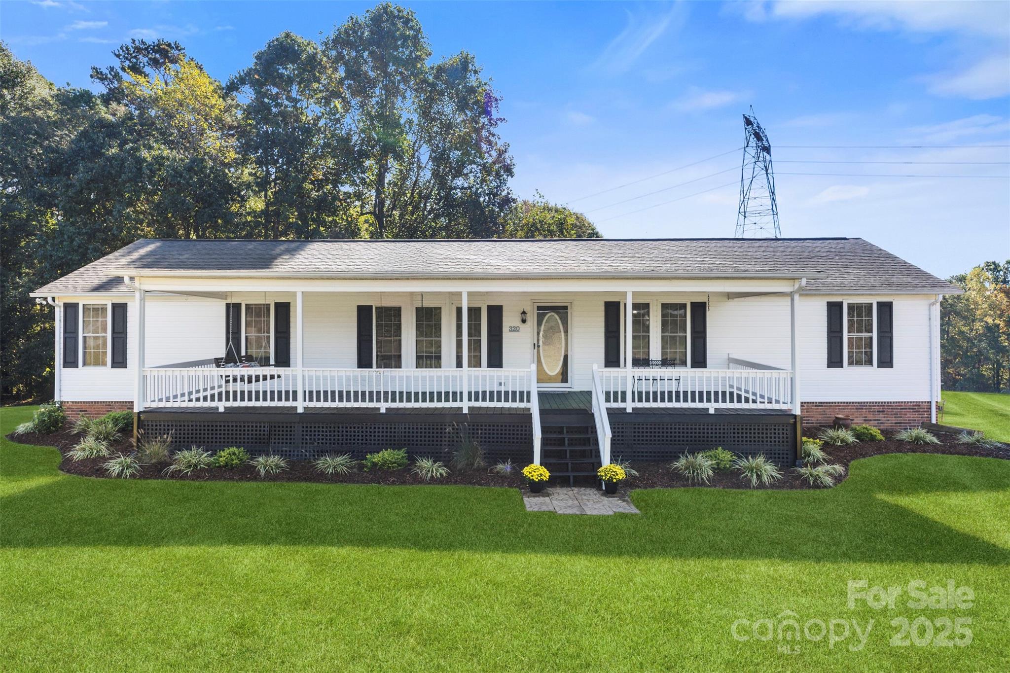 320 Huffstetler Lake Road Dallas, NC 28034 - Photo 1 of 47 a front view of a house with a yard