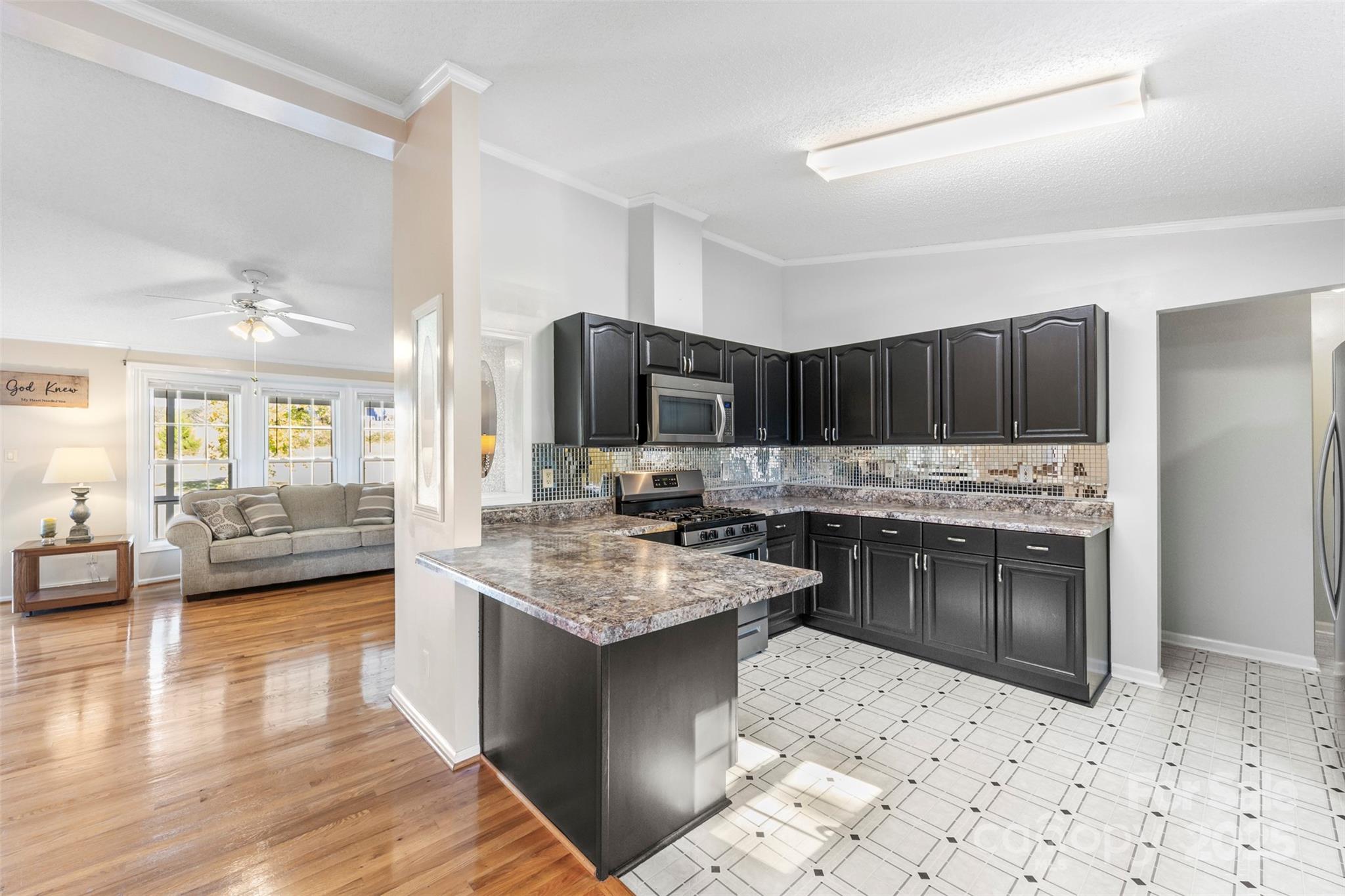 320 Huffstetler Lake Road Dallas, NC 28034 - Photo 14 of 47 a kitchen with a stove a sink and a refrigerator