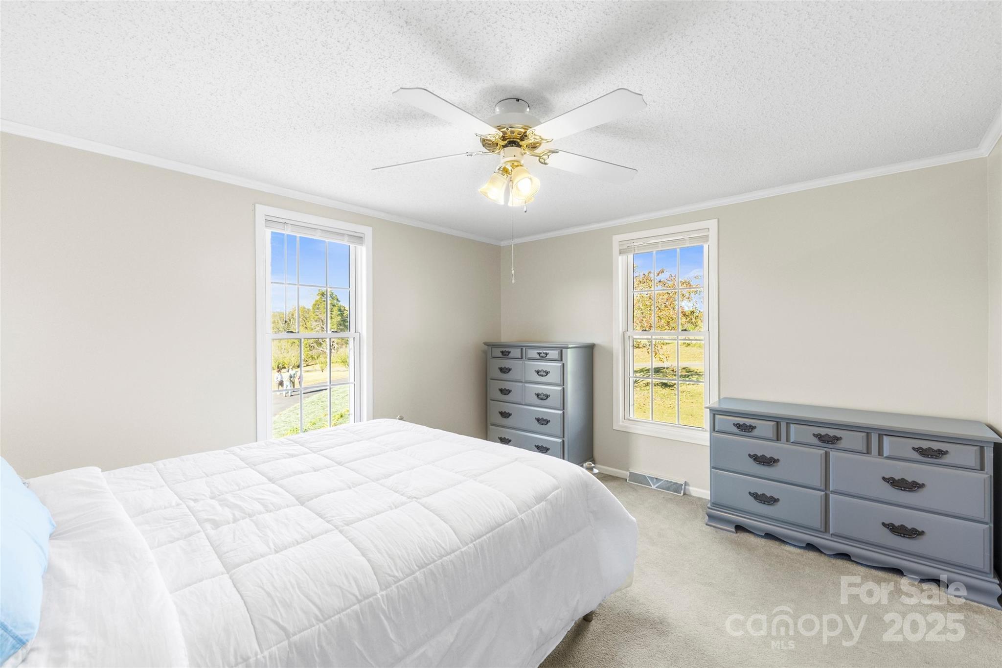 320 Huffstetler Lake Road Dallas, NC 28034 - Photo 17 of 47 a bedroom with a bed and a chandelier