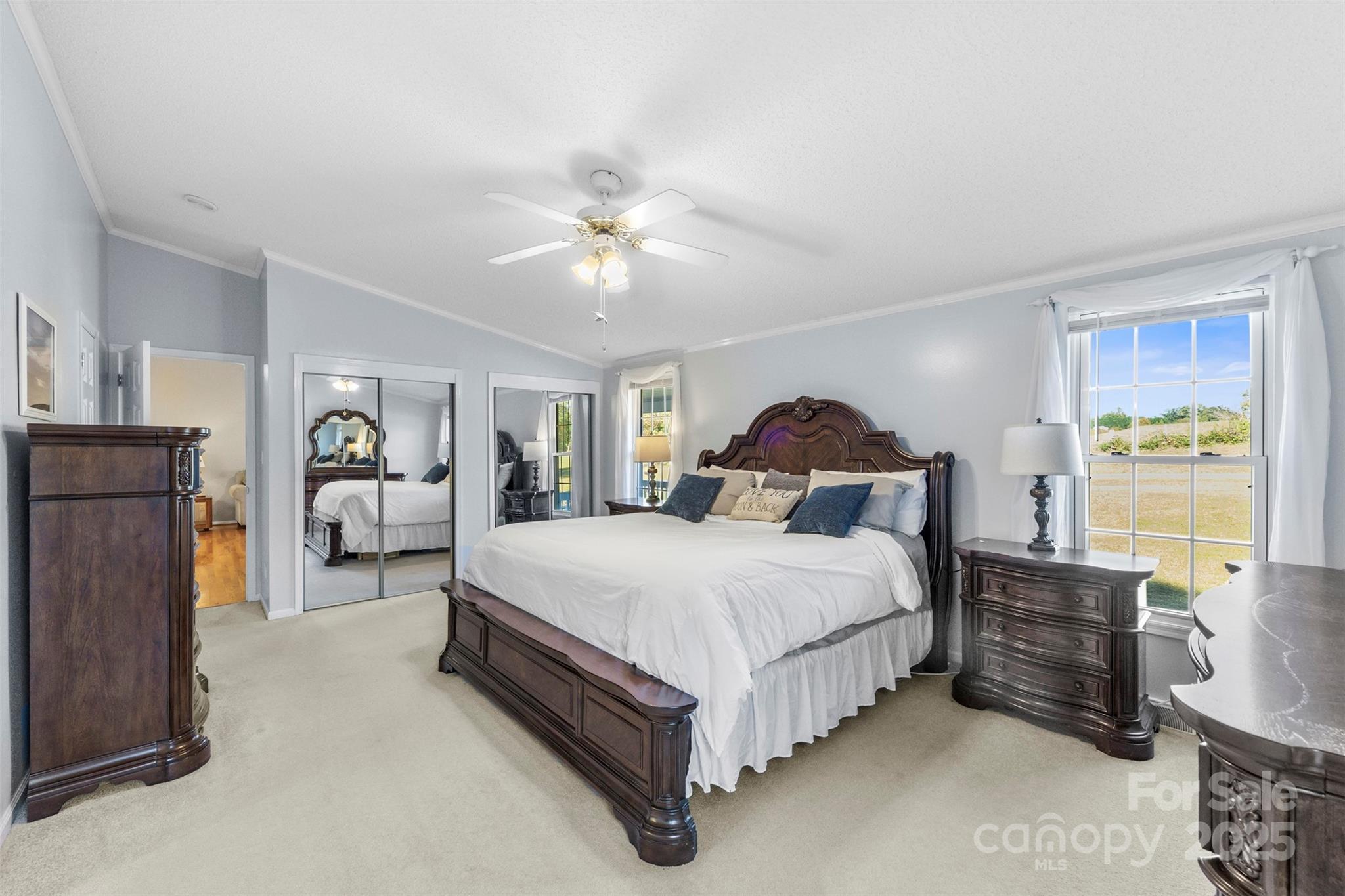 320 Huffstetler Lake Road Dallas, NC 28034 - Photo 18 of 47 a spacious bedroom with a bed and a chandelier