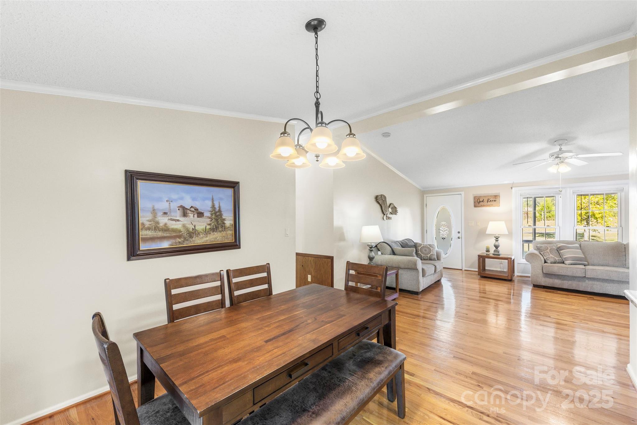 320 Huffstetler Lake Road Dallas, NC 28034 - Photo 19 of 47 a dining room with wooden floor a chandelier a wooden table and chairs