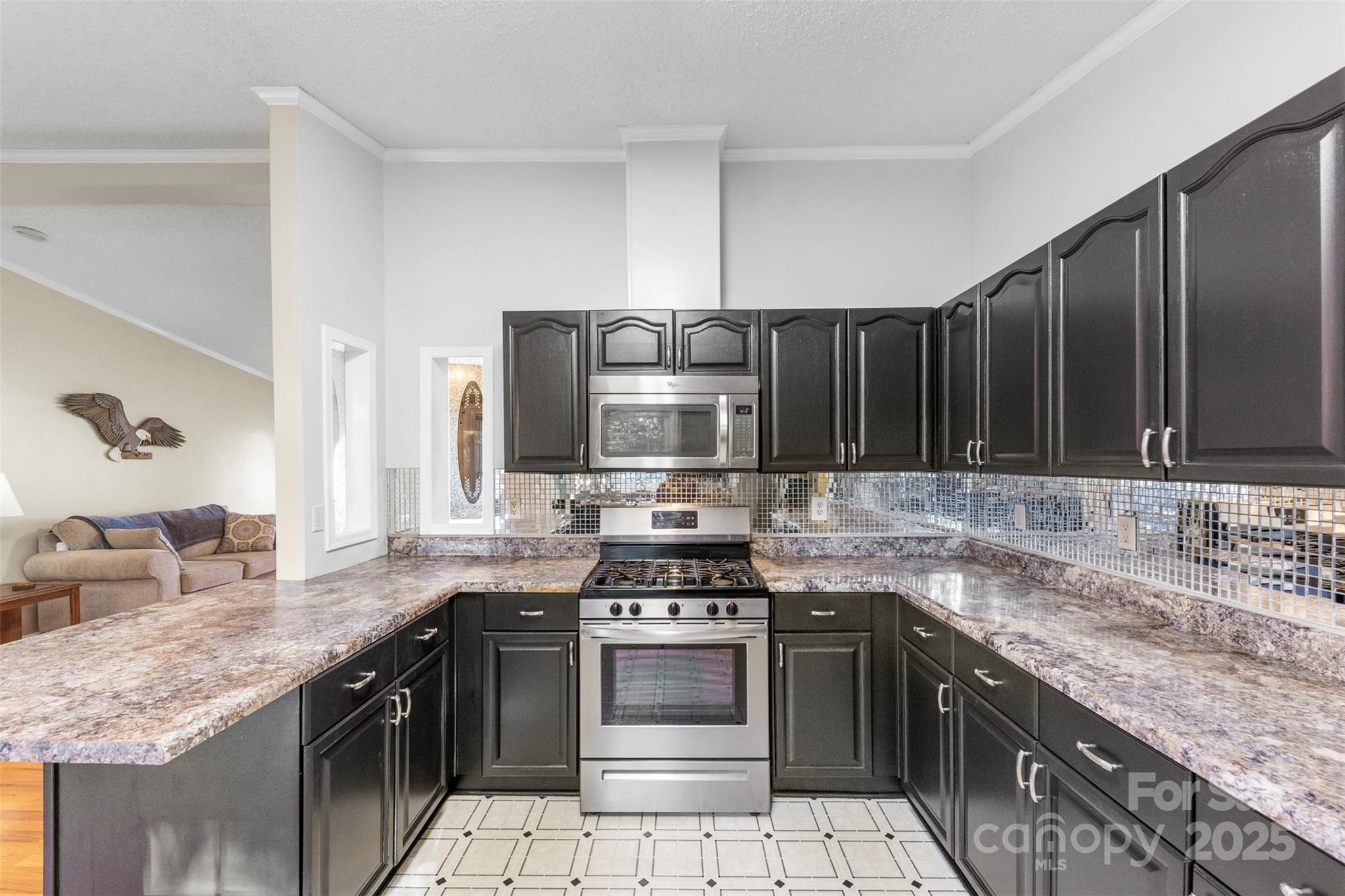 320 Huffstetler Lake Road Dallas, NC 28034 - Photo 20 of 47 a kitchen with stainless steel appliances granite countertop a sink stove and cabinets