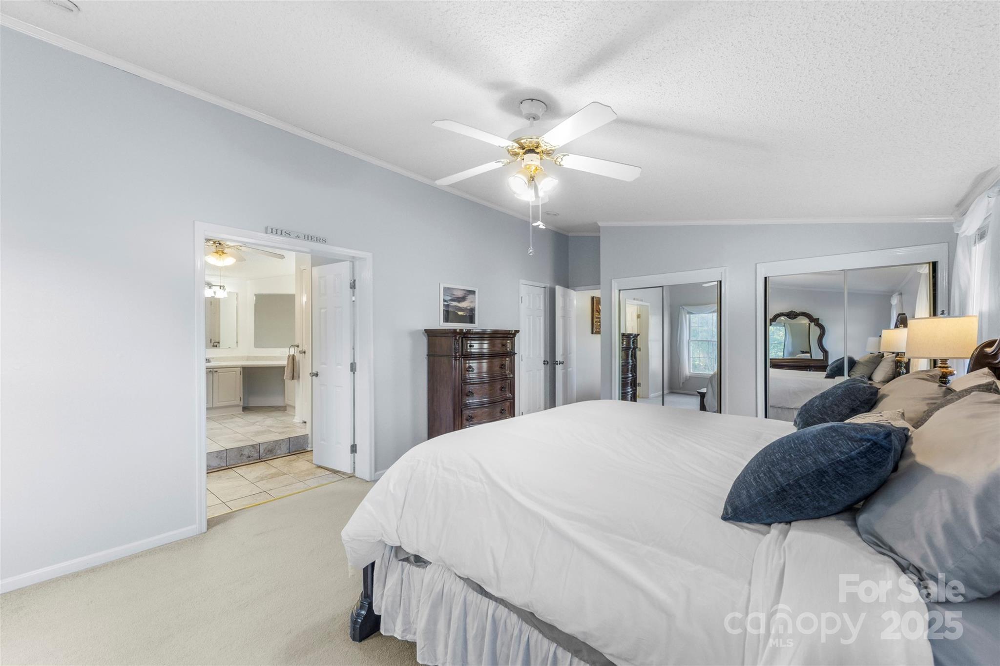 320 Huffstetler Lake Road Dallas, NC 28034 - Photo 21 of 47 a large bedroom with a bed and a chandelier