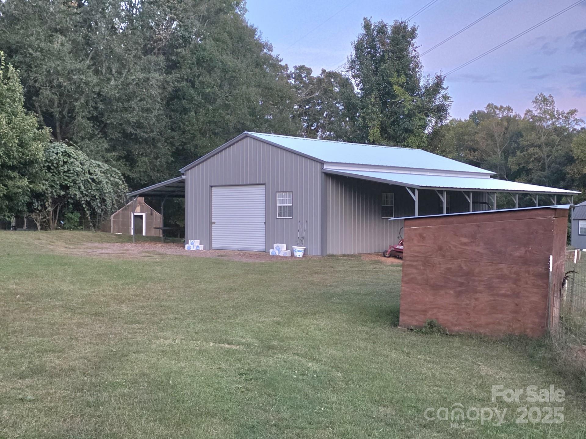 320 Huffstetler Lake Road Dallas, NC 28034 - Photo 30 of 47 a front view of a house with a yard and garage