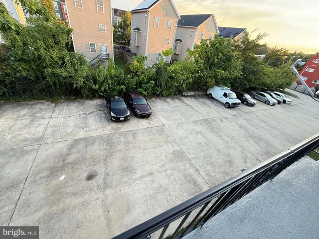 a kitchen with granite countertop a refrigerator a stove and a sink