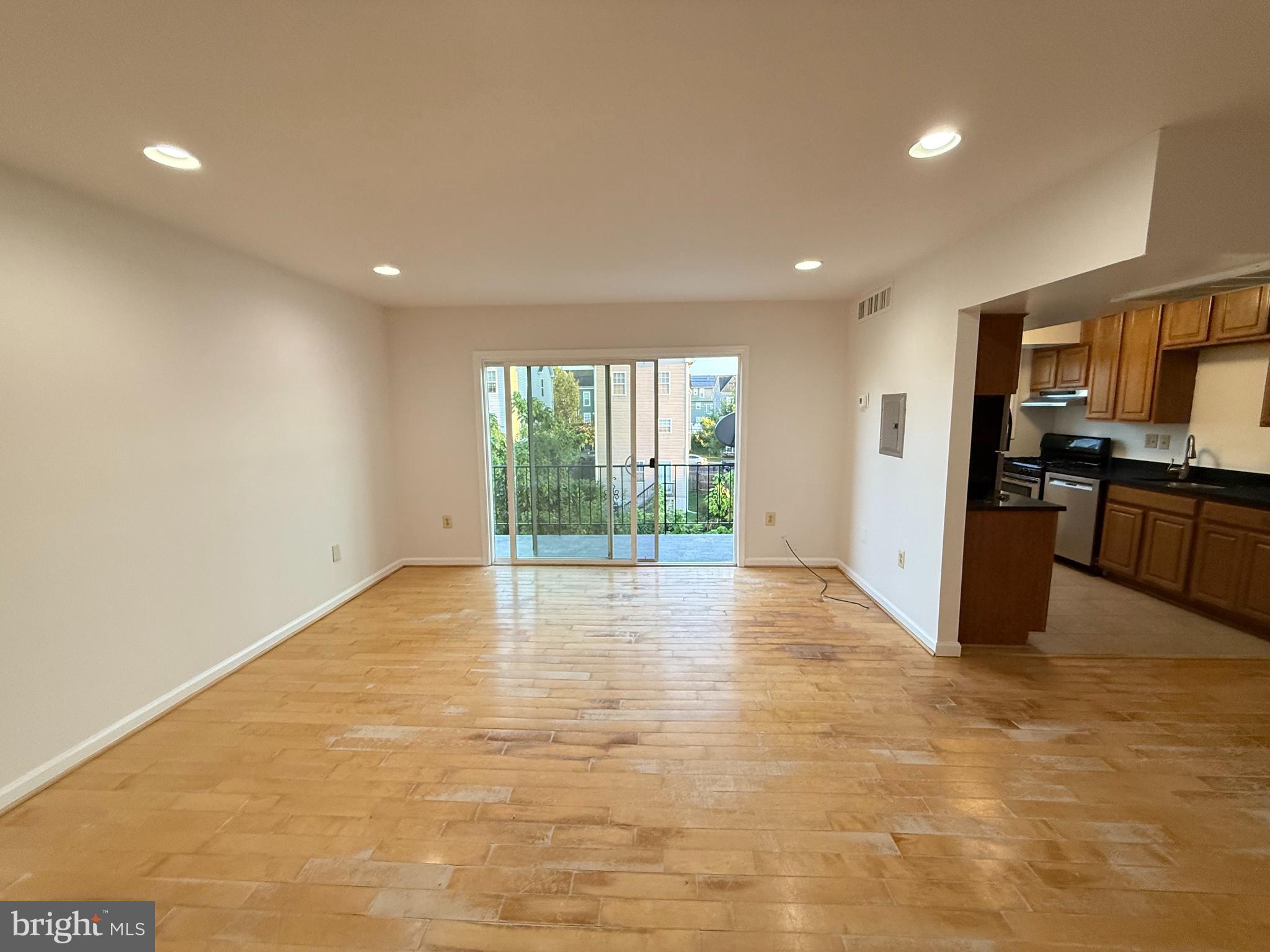 5009 D Street Southeast, Unit 303 Washington, DC 20019 - Photo 8 of 25 a view of an empty room with kitchen and a window