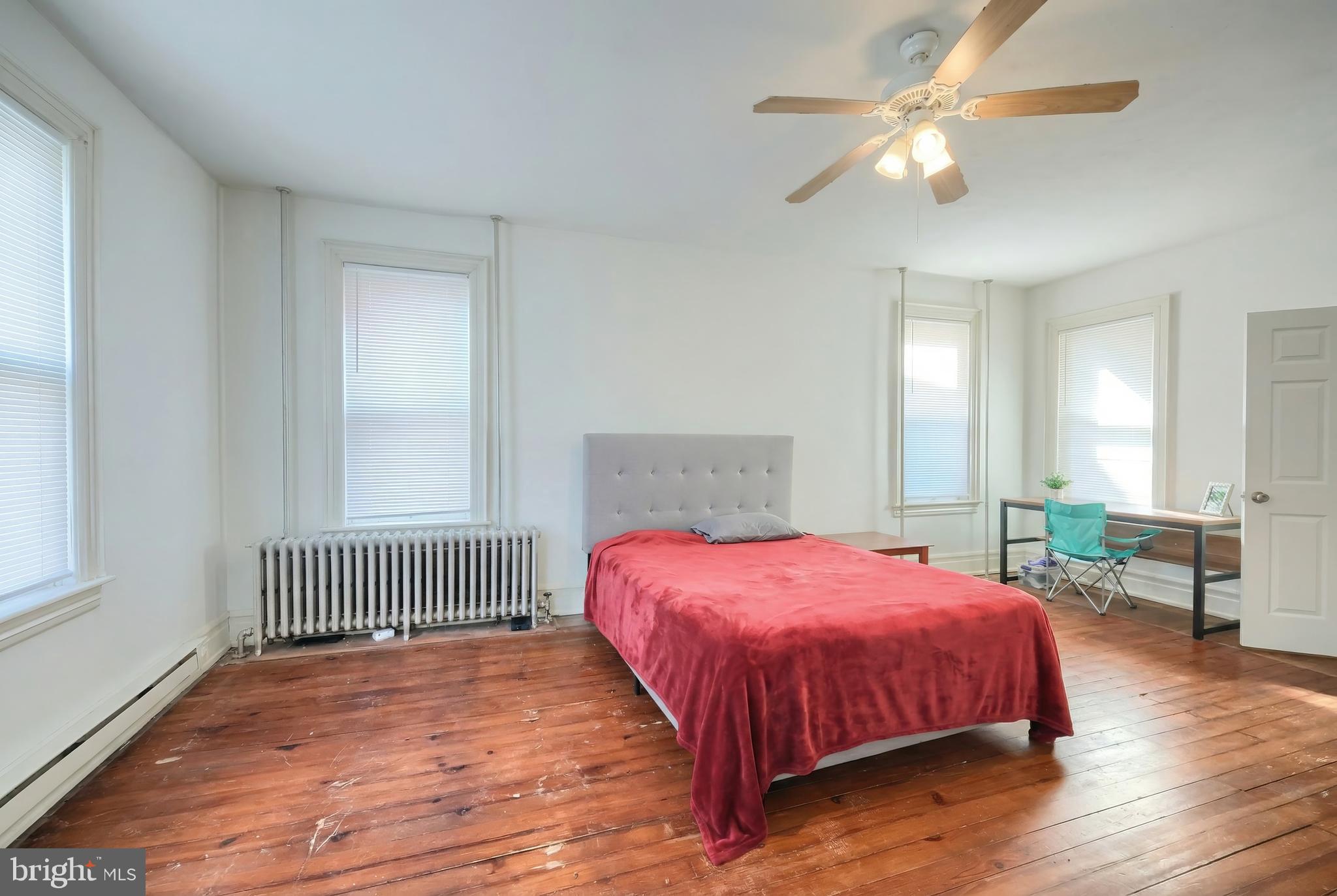 117 Baltimore Street Hanover, PA 17331 - Photo 13 of 37 a bedroom with a bed and a chandelier