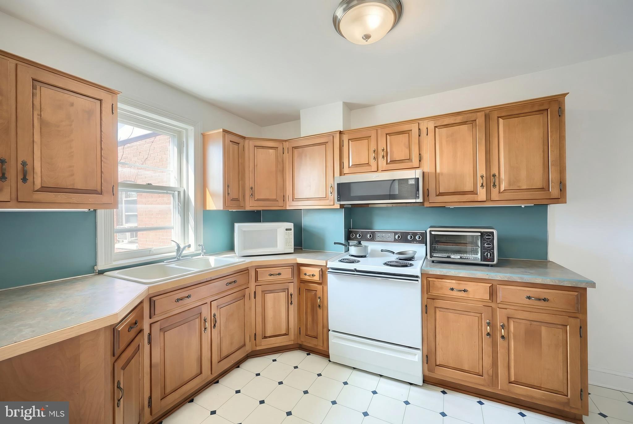 117 Baltimore Street Hanover, PA 17331 - Photo 26 of 37 a kitchen with cabinets appliances a sink and a window