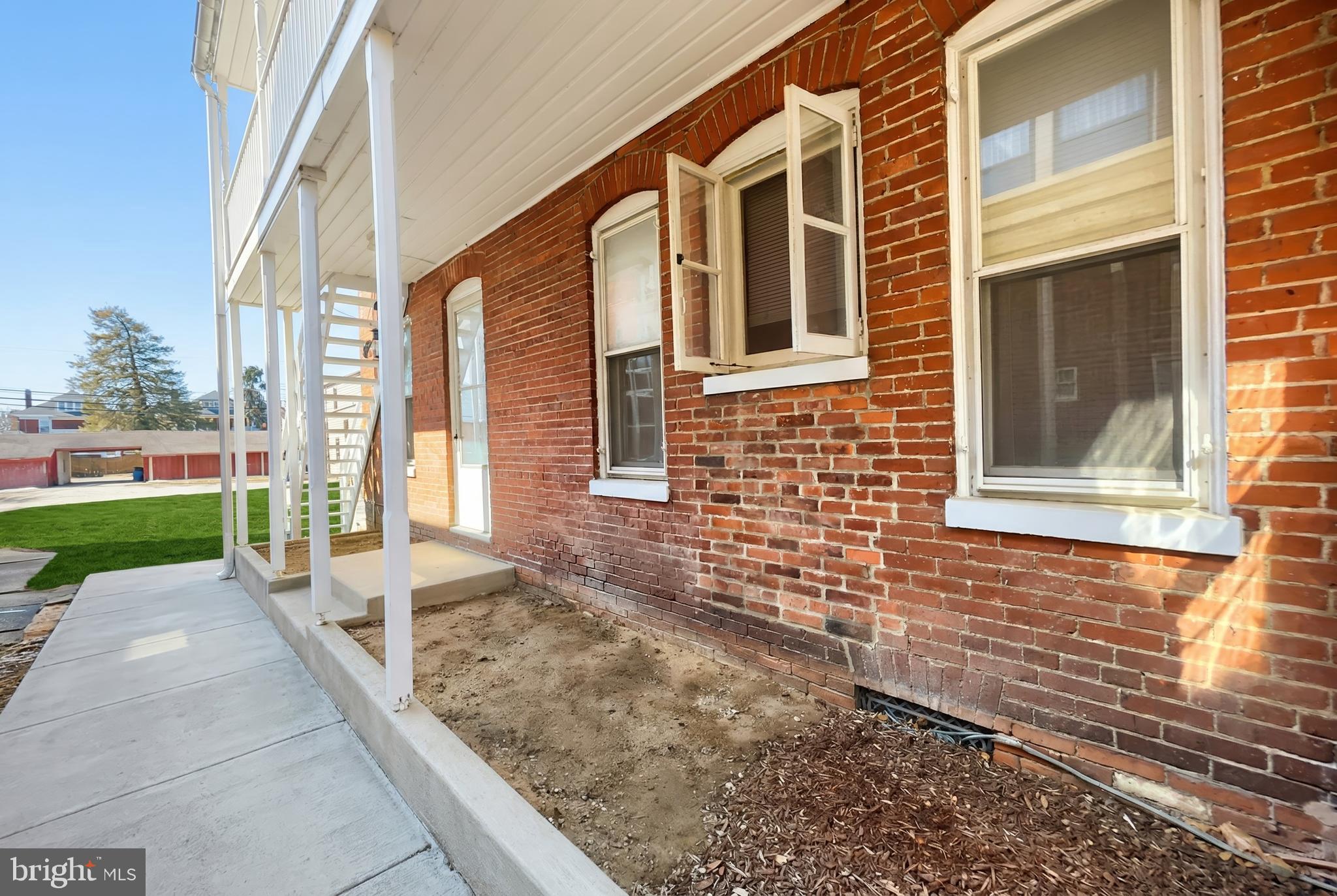 117 Baltimore Street Hanover, PA 17331 - Photo 6 of 37 a view of a brick house with many windows