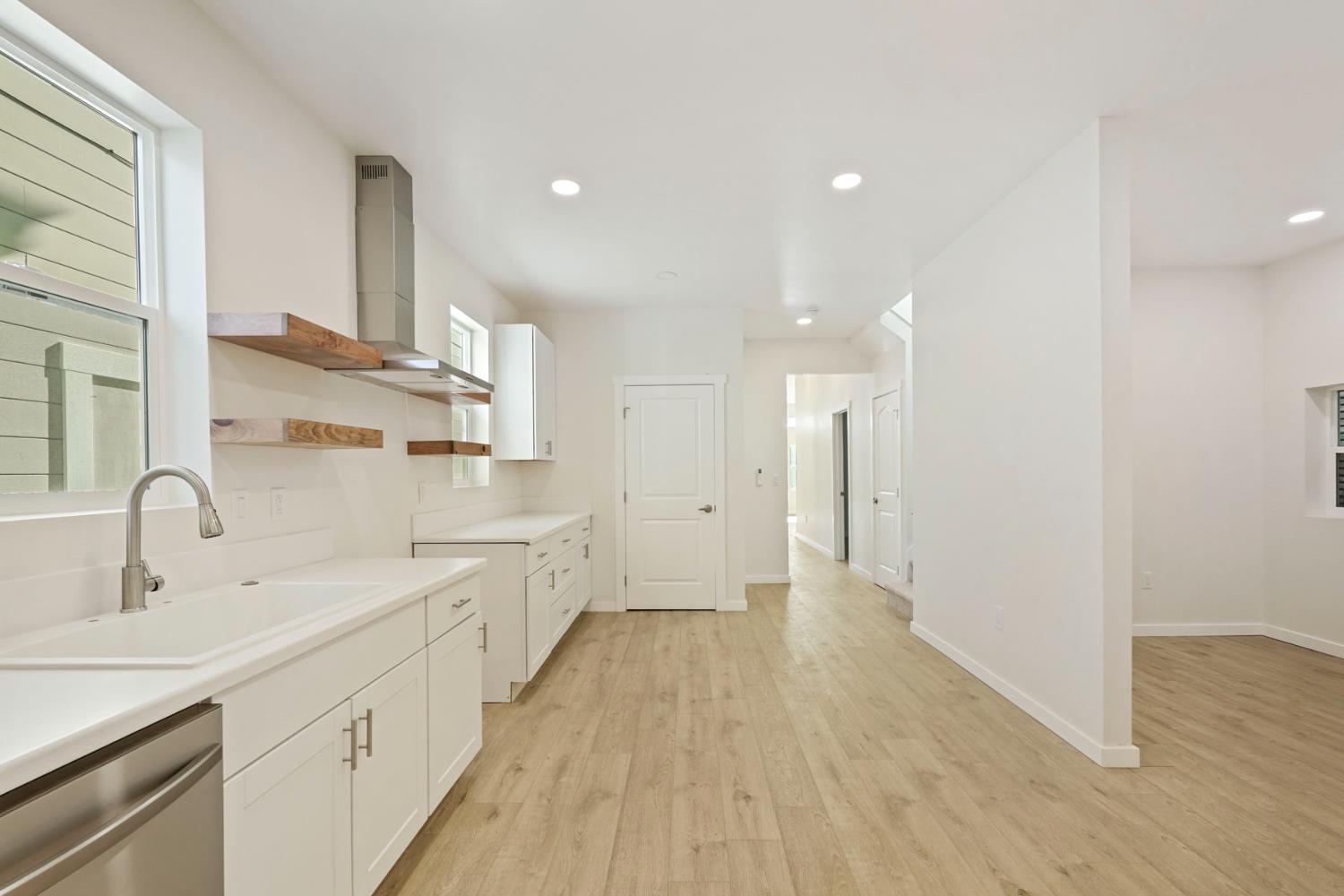 1269 B Street Walnut Grove, CA 95690 - Photo 14 of 42 a large kitchen with a sink and wooden floor