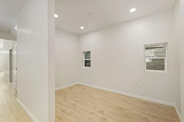 an empty room with windows and closet