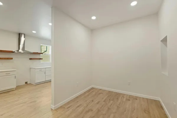 an empty room with a ceiling fan and a window