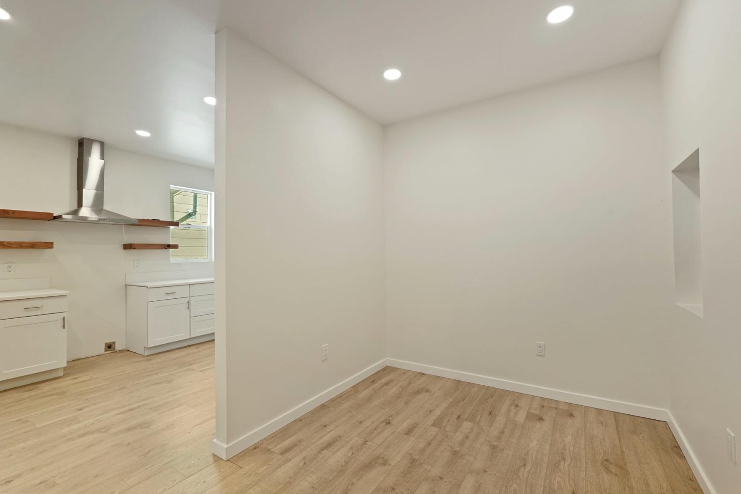 1269 B Street Walnut Grove, CA 95690 - Photo 17 of 42 a view of a kitchen with white cabinets and wooden floor