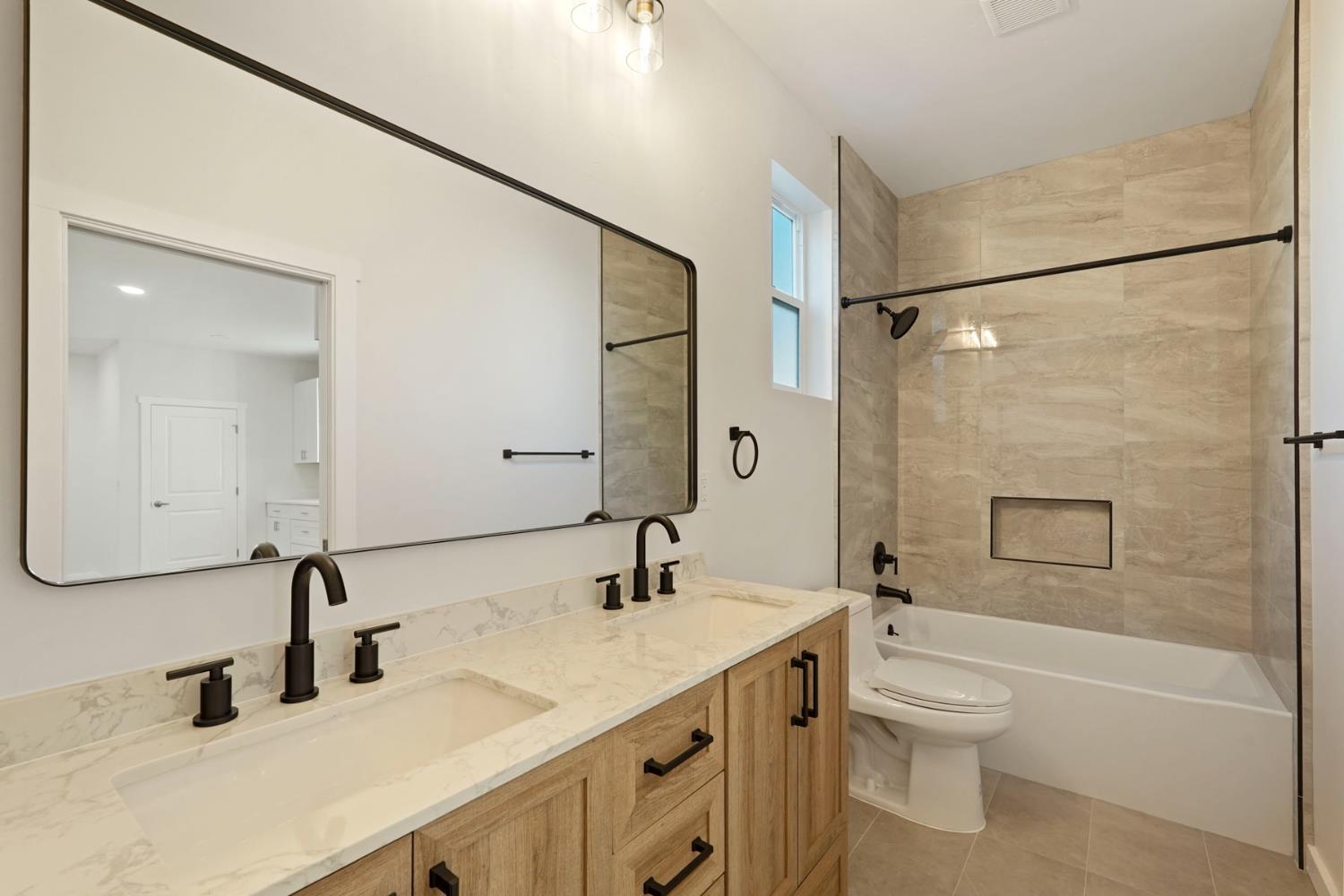 1269 B Street Walnut Grove, CA 95690 - Photo 19 of 42 a bathroom with a double vanity sink toilet mirror and shower