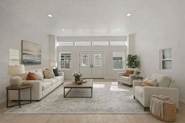 a kitchen with white cabinets and sink