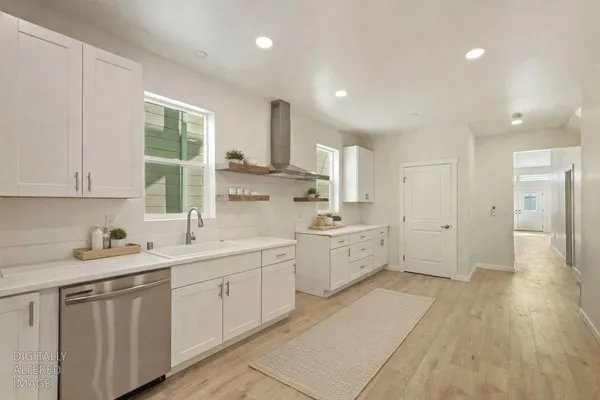a bathroom with a double vanity sink toilet mirror and shower
