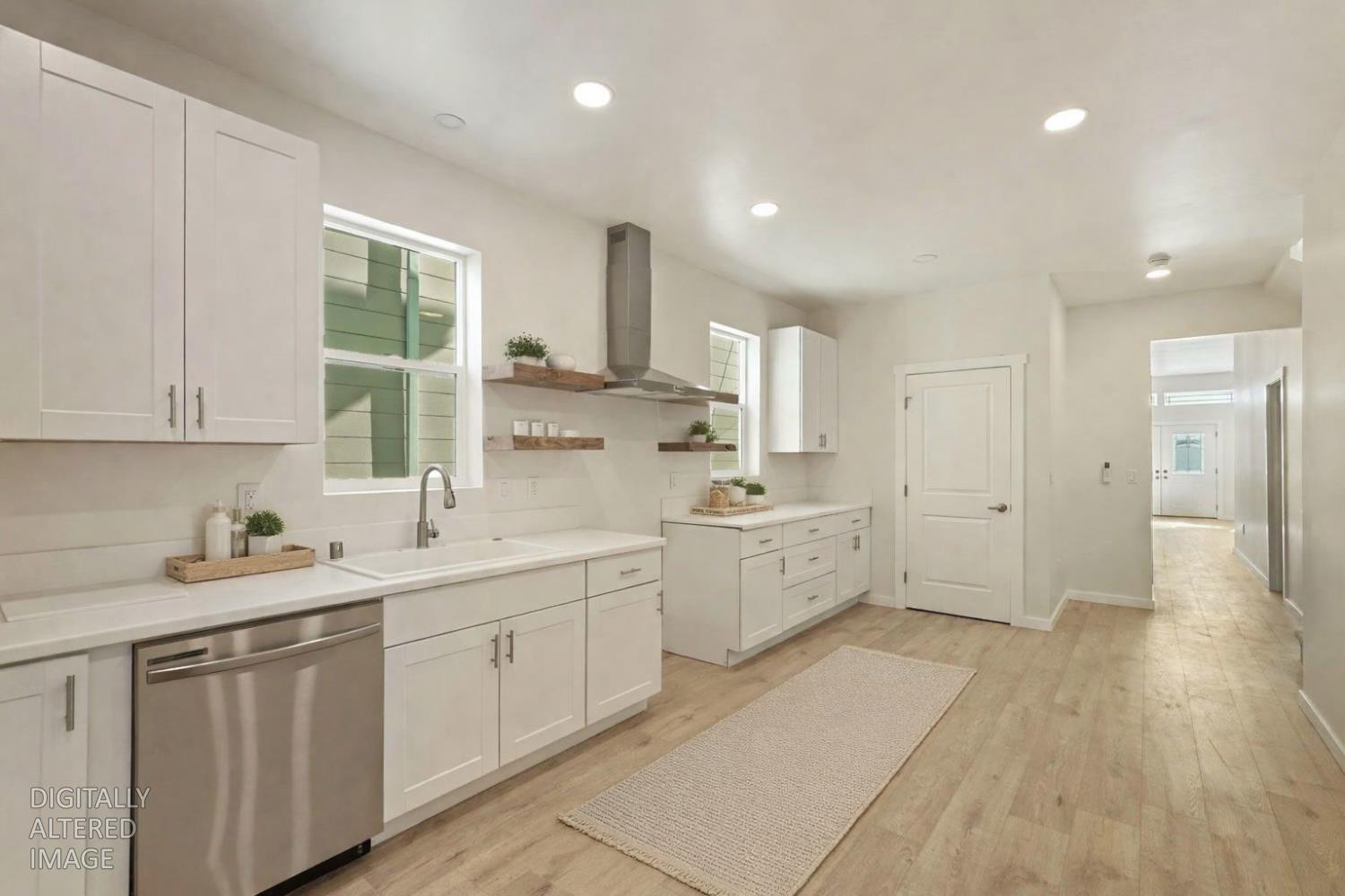 1269 B Street Walnut Grove, CA 95690 - Photo 9 of 42 a large white kitchen with a white cabinets and wooden floor