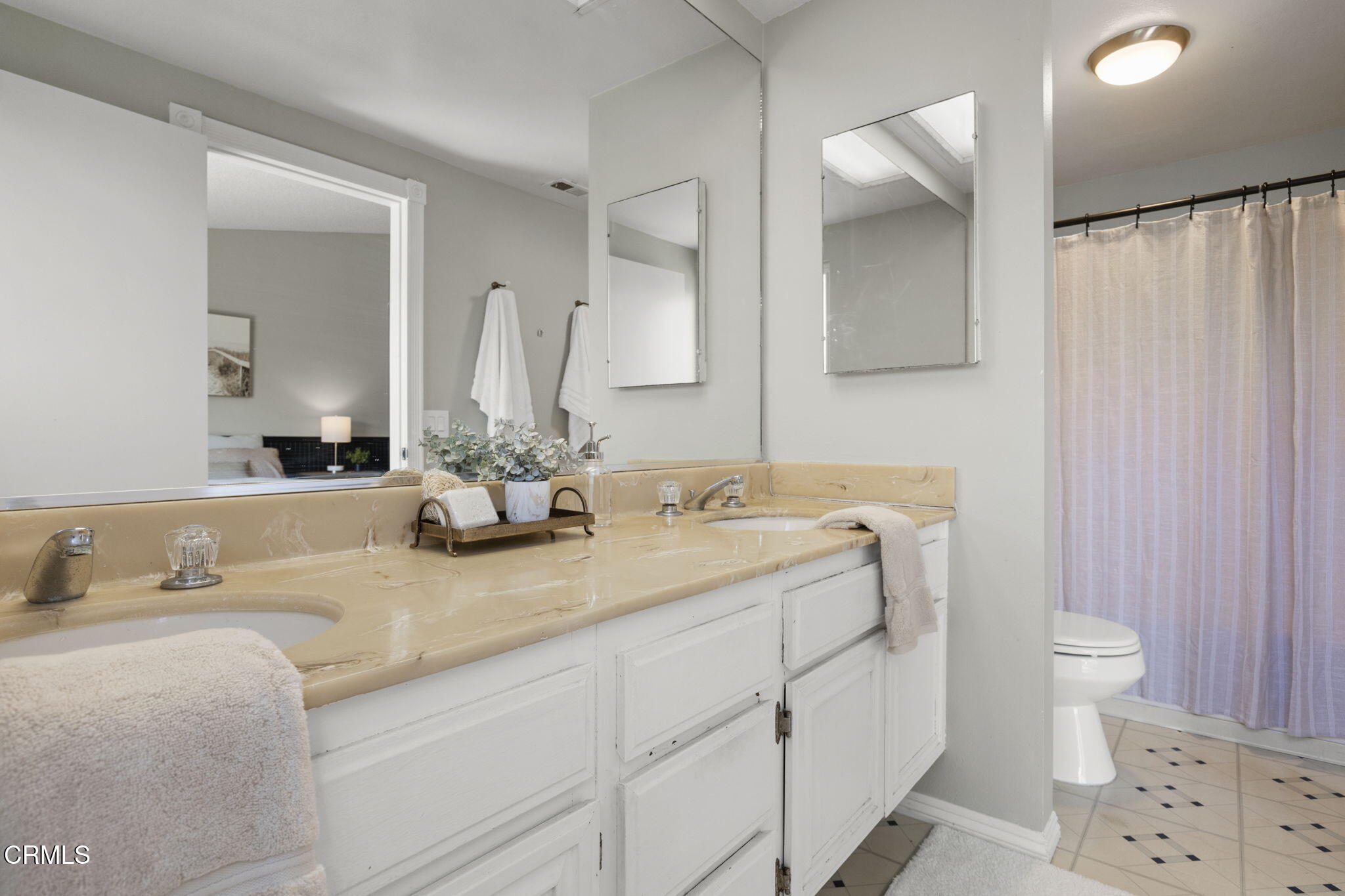 2730 Oarfish Lane Oxnard, CA 93035 - Photo 24 of 49 a bathroom with a double vanity sink and a mirror