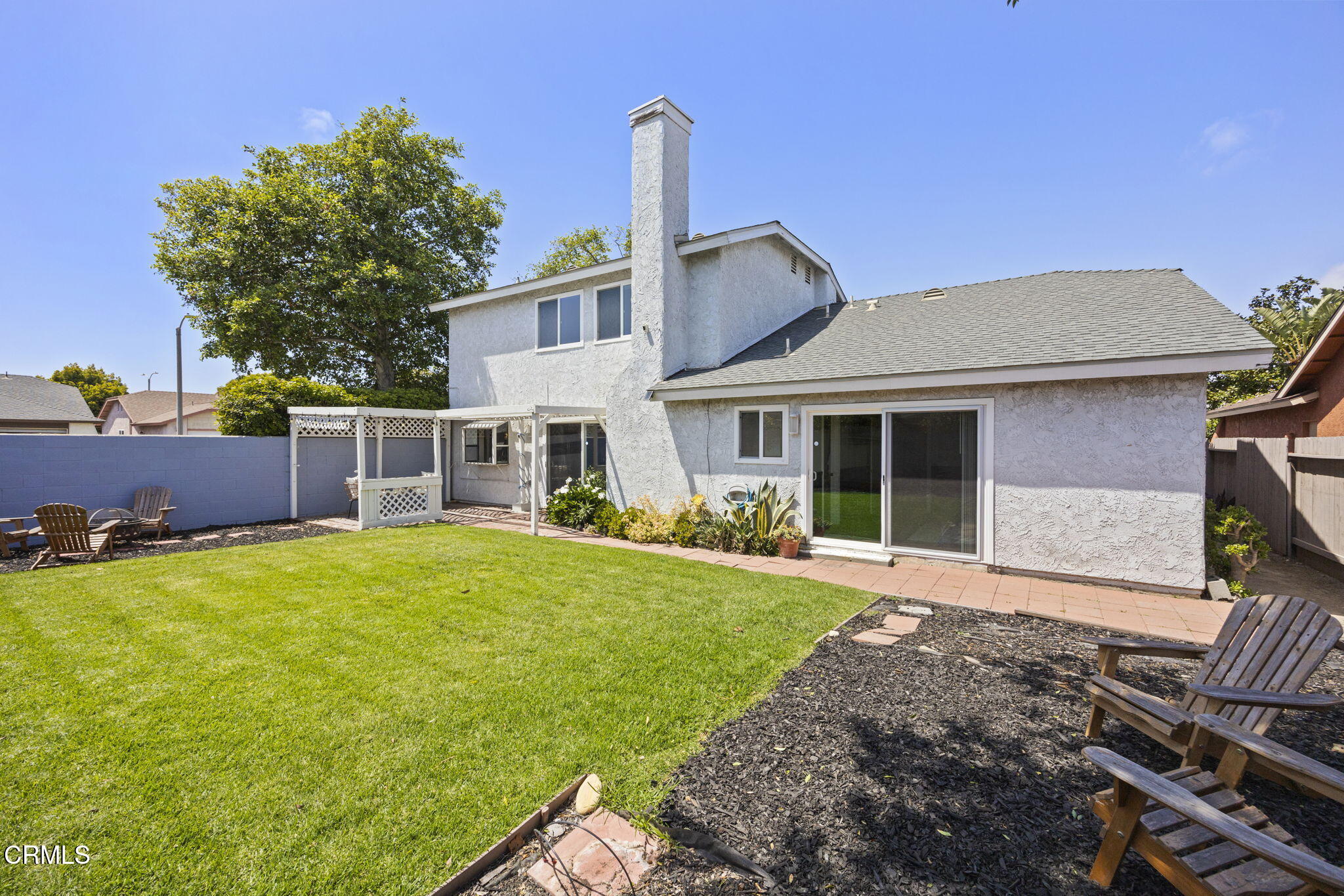 2730 Oarfish Lane Oxnard, CA 93035 - Photo 40 of 49 a front view of a house with a garden and yard