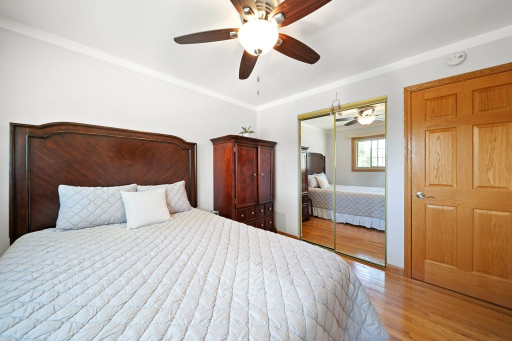 365 West Myrick Avenue Addison, IL 60101 - Photo 26 of 49 a bedroom with a large bed and a chandelier