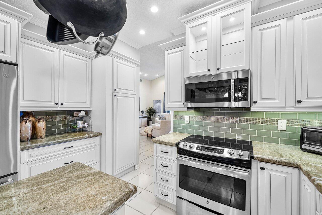 7155 Via Palomar Boca Raton, FL 33433 - Photo 12 of 45 a kitchen with stainless steel appliances granite countertop a stove and a microwave
