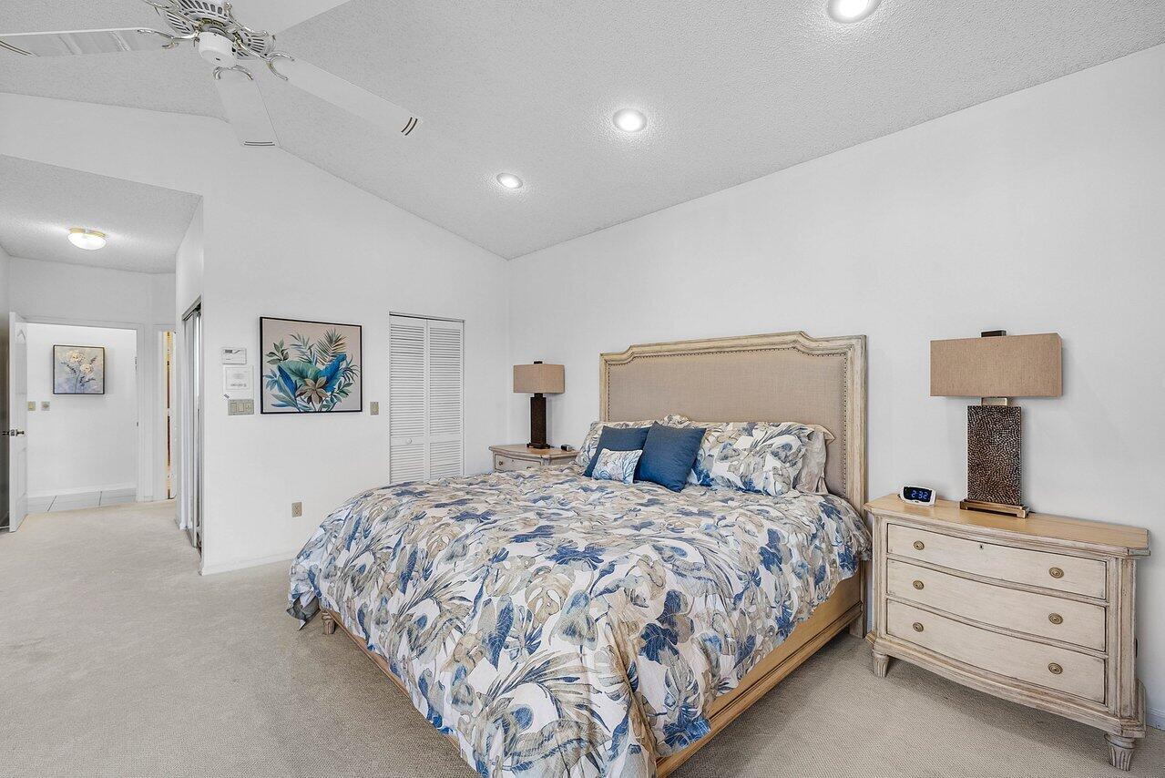 7155 Via Palomar Boca Raton, FL 33433 - Photo 17 of 45 a bedroom with a bed and a lamp on dresser