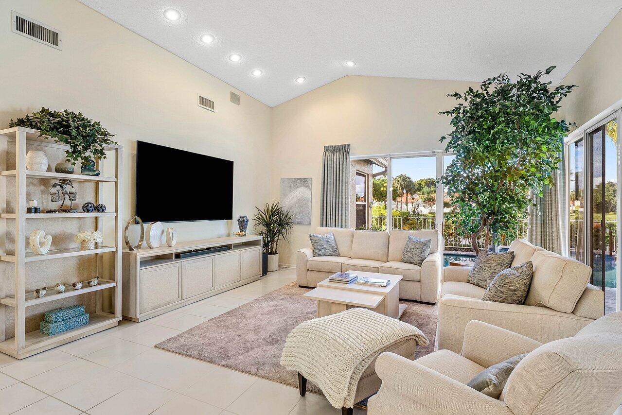 7155 Via Palomar Boca Raton, FL 33433 - Photo 7 of 45 a living room with furniture a flat screen tv and a potted plant