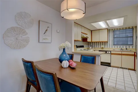 a kitchen with a table chairs sink and cabinets