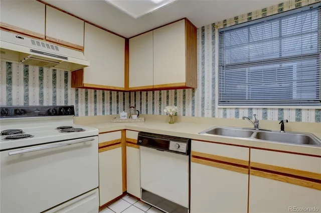 a kitchen that has a sink and a stove