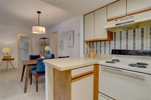 a kitchen that has a table and chairs in it